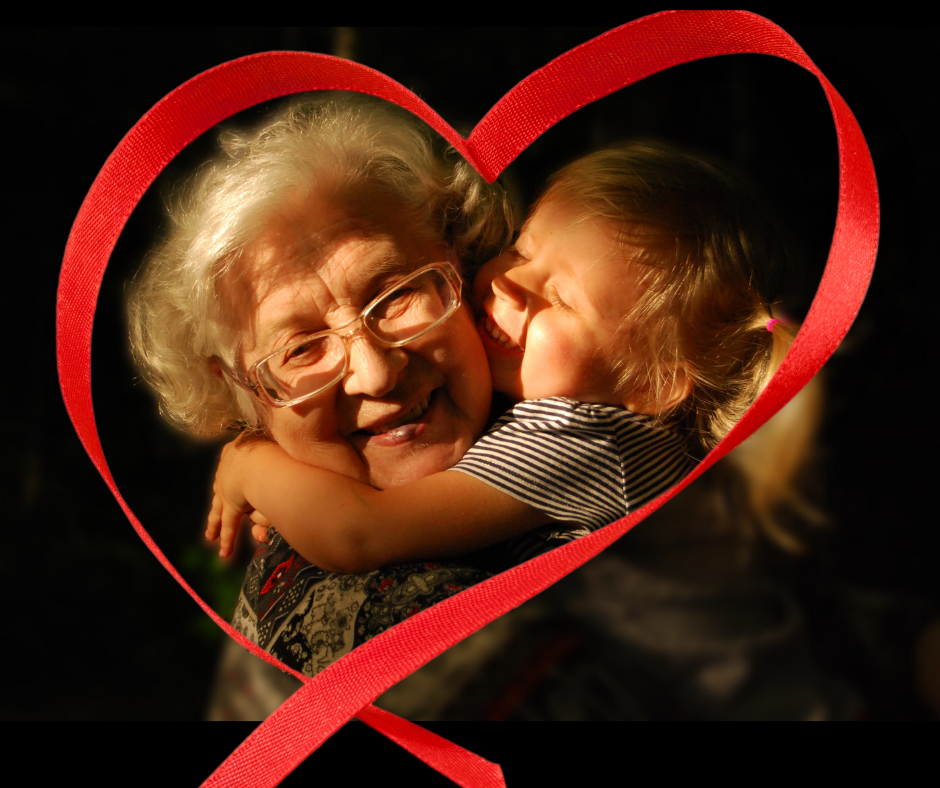grandma hugging granddaughter in heart ribbon