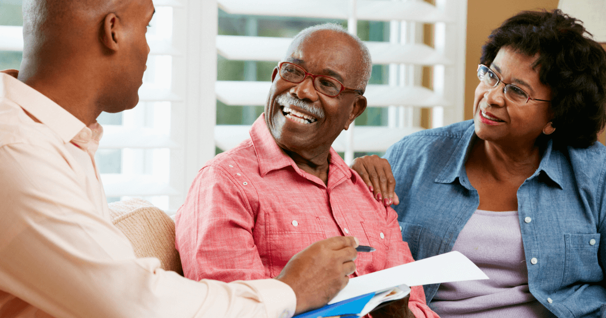Elder couple speaking with gentleman about funding sources for senior care.