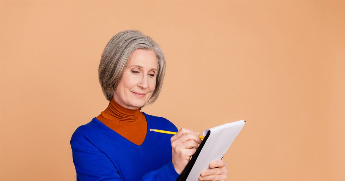 Photo of a senior female taking notes