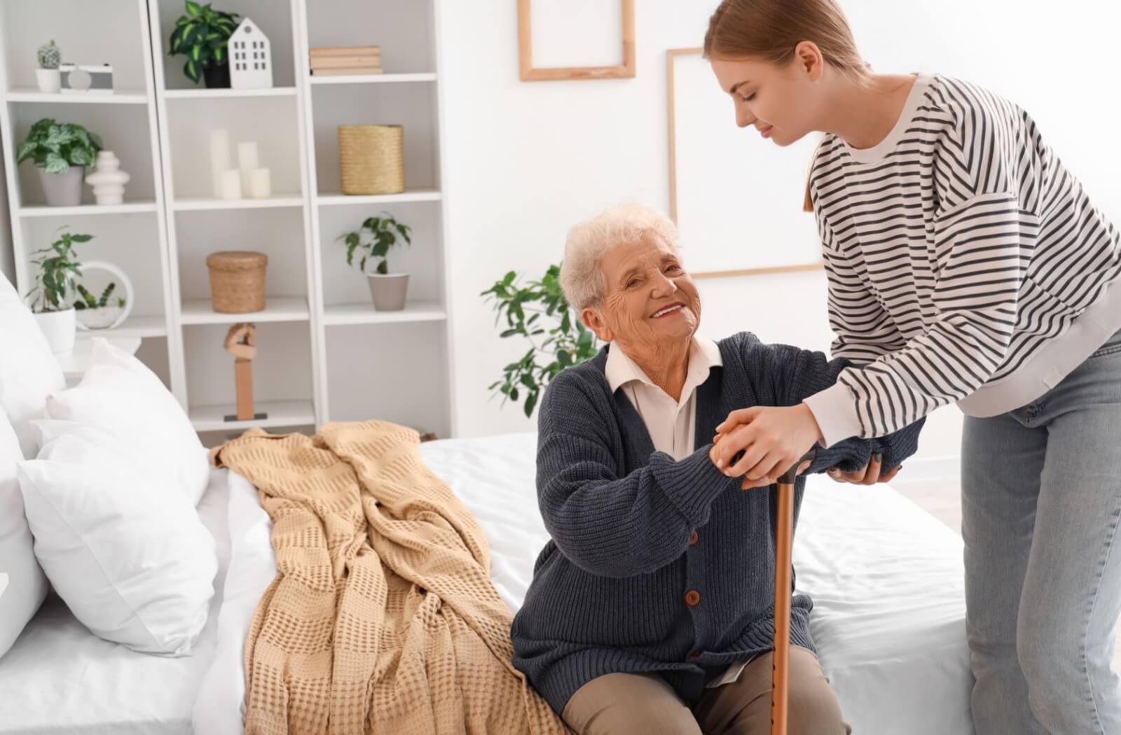 a caregiver helping their senior loved one to get up.